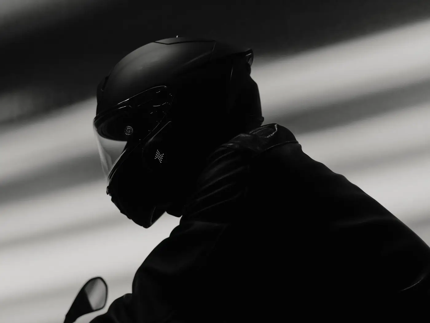 Rider from behind at night, Rogue LED matrix lit on the helmet